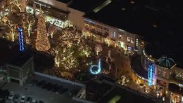 HD stock footage aerial video of circling a fountain at The Grove shopping mall at night in Los Angeles, California Aerial Stock Footage | CAP_018_151