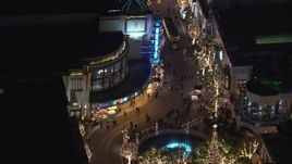 HD stock footage aerial video of the fountain at The Grove shopping mall, decorated for the holidays at night in Los Angeles, California Aerial Stock Footage | CAP_018_157