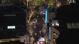 HD stock footage aerial video of holiday decorations and fountain at The Grove shopping mall at night in Los Angeles, California Aerial Stock Footage | CAP_018_161