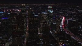 HD stock footage aerial video of flying way from tall skyscrapers at night, Downtown Los Angeles, California Aerial Stock Footage | CAP_018_207