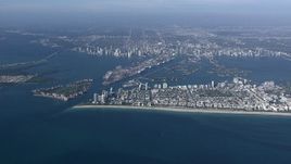 HD stock footage aerial video of approaching South Beach with a wide view of the bay, port and islands near Downtown Miami, Florida Aerial Stock Footage | CAP_020_009
