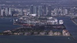 HD stock footage aerial video of the port behind Fisher Island, downtown skyline in background, Miami, Florida Aerial Stock Footage | CAP_020_025
