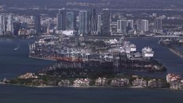 HD stock footage aerial video of passing Fisher Island, Port of Miami and downtown skyline, Florida Aerial Stock Footage | CAP_020_026