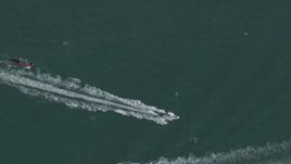 HD stock footage aerial video of a bird's eye view of a boat racing across the water near Miami, Florida Aerial Stock Footage | CAP_020_035