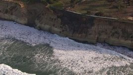 HD stock footage aerial video of orbit waves rolling in toward coastal cliffs, Del Mar, California Aerial Stock Footage | CAP_021_008