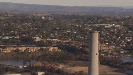 HD stock footage aerial video of circling the power plant smoke stack in Carlsbad, California Aerial Stock Footage | CAP_021_017