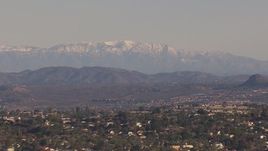 HD stock footage aerial video of distant snow mountains seen from hillside homes, Carlsbad, California Aerial Stock Footage | CAP_021_020