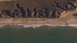 HD stock footage aerial video of zooming to an empty strip of beach by cliffs on the coast, Oceanside, California Aerial Stock Footage | CAP_021_040