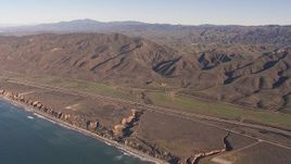HD stock footage aerial video of I-5 between mountains and coastal cliffs, San Clemente, California Aerial Stock Footage | CAP_021_041