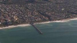HD stock footage aerial video of flying away from a pier by coastal neighborhoods in San Clemente, California Aerial Stock Footage | CAP_021_057