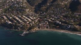 HD stock footage aerial video flying by beach and oceanfront mansions in Laguna Beach, California Aerial Stock Footage | CAP_021_069