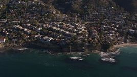 HD stock footage aerial video flying by and away from oceanfront mansions in Laguna Beach, California Aerial Stock Footage | CAP_021_070