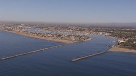 HD stock footage aerial video of flying by the inlet to the bay by coastal neighborhoods, Newport Beach, California Aerial Stock Footage | CAP_021_074