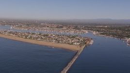 HD stock footage aerial video of passing by the inlet to the bay by coastal neighborhoods, Newport Beach, California Aerial Stock Footage | CAP_021_075