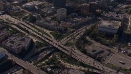 HD stock footage aerial video orbit the 101 / 110 interchange with heavy traffic, tilt to reveal skyline, Downtown Los Angeles, California Aerial Stock Footage | CAP_021_107