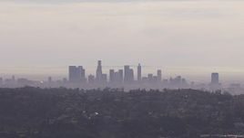 HD stock footage aerial video of a wide view of the city's skyline on a hazy day, seen from Hollywood Hills, Downtown Los Angeles, California Aerial Stock Footage | CAP_021_128