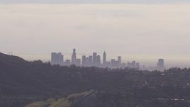 HD stock footage aerial video of the city's skyline on a hazy day, seen from Hollywood Hills, Downtown Los Angeles, California Aerial Stock Footage | CAP_021_129