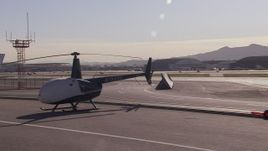 HD stock footage aerial video of passing civilian jets and helicopters by a Burbank Airport hangar, California Aerial Stock Footage | CAP_021_137
