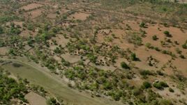 HD stock footage aerial video approach and tilt to a village in open savanna, Zimbabwe Aerial Stock Footage | CAP_026_014
