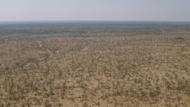 HD stock footage aerial video of flying over a wide expanse of savanna, Zimbabwe Aerial Stock Footage | CAP_026_035