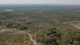 HD stock footage aerial video of flying over hills and fields toward savanna, Zimbabwe Aerial Stock Footage | CAP_026_063