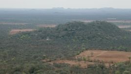 HD stock footage aerial video of a hill and fields in the savanna, Zimbabwe Aerial Stock Footage | CAP_026_068