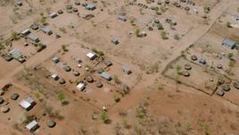 HD stock footage aerial video of tilting to a bird's eye view of huts in a village, Zimbabwe Aerial Stock Footage | CAP_026_071