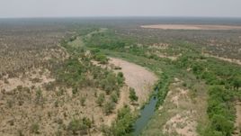 HD stock footage aerial video of following a narrow river past trees in savanna, Zimbabwe Aerial Stock Footage | CAP_026_073