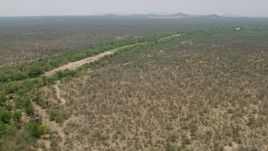 HD stock footage aerial video of passing by a dry riverbed and trees in savanna, Zimbabwe Aerial Stock Footage | CAP_026_078