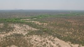 HD stock footage aerial video of a dry riverbed and trees in savanna, Zimbabwe Aerial Stock Footage | CAP_026_079