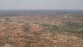 HD stock footage aerial video of flying by a village surrounded by savanna, Botswana Aerial Stock Footage | CAP_026_081