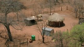 HD stock footage aerial video of circling a wooden hut in the village, Botswana Aerial Stock Footage | CAP_026_085