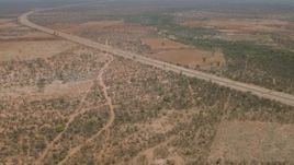 HD stock footage aerial video of approaching a road outside the village, Botswana Aerial Stock Footage | CAP_026_091