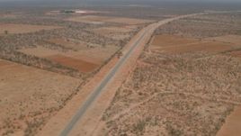 HD stock footage aerial video approach and tilt to a bird's eye of the road outside the village, Botswana Aerial Stock Footage | CAP_026_092