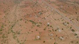 HD stock footage aerial video of orbiting homes in a village near the road in Zimbabwe Aerial Stock Footage | CAP_026_104