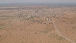 HD stock footage aerial video of flying toward a road and tilt to reveal a village in Zimbabwe Aerial Stock Footage | CAP_026_107