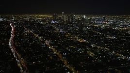 5K aerial stock footage tilt up revealing downtown Los Angeles skyline at night, California Aerial Stock Footage | DCA01_009