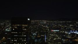 5K aerial stock footage flying between Paul Hastings Tower and Union Bank Plaza toward Hollywood city lights at night, Los Angeles, California Aerial Stock Footage | DCA01_018
