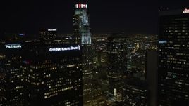 5K aerial stock footage flying by skyscrapers revealing Los Angeles City Hall at night, California Aerial Stock Footage | DCA01_025