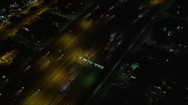 5K aerial stock footage tracking traffic on Highway 110, tilt up to reveal Hwy 110/ I-105 interchange at night, Los Angeles, California Aerial Stock Footage | DCA01_066
