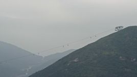 4K aerial stock footage of the Ngong Ping Cable Car gondolas on Lantau Island, Hong Kong, China Aerial Stock Footage | DCA02_002