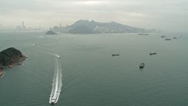 4K aerial stock footage approach ferries and cargo ships near Hong Kong Island and Victoria Harbor, China Aerial Stock Footage | DCA02_009