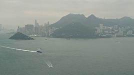 4K aerial stock footage approach Hong Kong Island as a ferry passes, China Aerial Stock Footage | DCA02_010