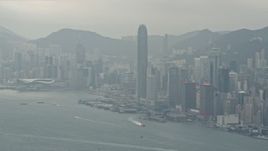 4K aerial stock footage tilt from a ferry and pan across Hong Kong Island and Victoria Harbor to reveal Kowloon, China Aerial Stock Footage | DCA02_015