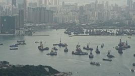 4K aerial stock footage tilt from ships in Victoria Harbor to reveal Kowloon apartment complexes, Hong Kong, China Aerial Stock Footage | DCA02_016