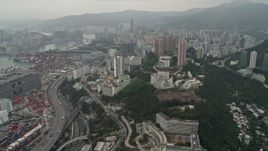 4K aerial stock footage pan from Port of Hong Kong and office buildings to reveal Kwai Chung apartment buildings, Hong Kong, China Aerial Stock Footage | DCA02_018