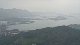 4K aerial stock footage flyby Tolo Harbor to reveal Tai Po apartment buildings in the New Territories, Hong Kong, China Aerial Stock Footage | DCA02_026