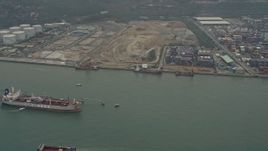4K aerial stock footage of oil tanker near cargo containers at Pillar Point port, New Territories, Hong Kong, China Aerial Stock Footage | DCA02_055