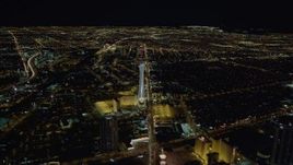 4K aerial stock footage approaching Stratosphere with city sprawl in background, Las Vegas, Nevada Night Aerial Stock Footage | DCA03_001