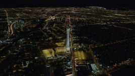 4K aerial stock footage approaching Stratosphere with city sprawl in background, Las Vegas, Nevada Night Aerial Stock Footage | DCA03_002